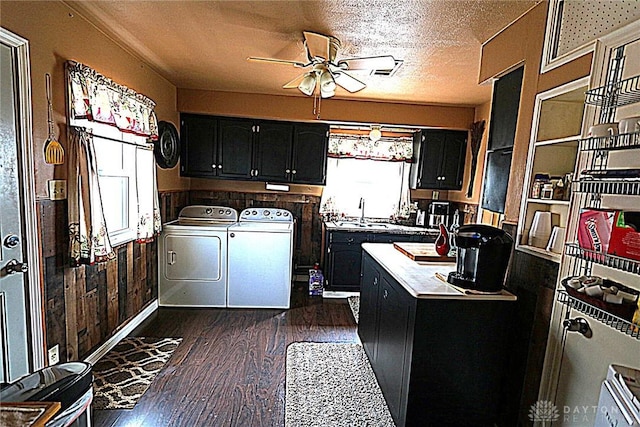 2311 Eden Ln, Dayton, OH 45431 - kitchen featuring washer and dryer, dark cabinetry, ceiling fan, dark wood finished floors, and a sink