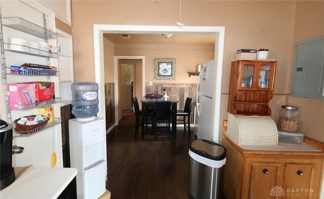 2311 Eden Ln, Dayton, OH 45431 - kitchen featuring freestanding refrigerator, dark wood-style flooring, electric panel, light countertops, and brown cabinetry
