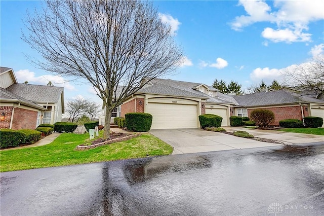3949 E Summit Ridge Dr, Beavercreek, OH 45430 - view of front of home with a garage, brick siding, driveway, and a front lawn