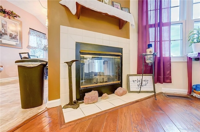 3949 E Summit Ridge Dr, Beavercreek, OH 45430 - detailed view of wood finished floors, a tiled fireplace, and baseboards