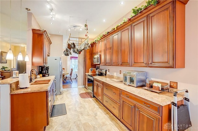 3949 E Summit Ridge Dr, Beavercreek, OH 45430 - kitchen featuring stainless steel appliances, a sink, and brown cabinets