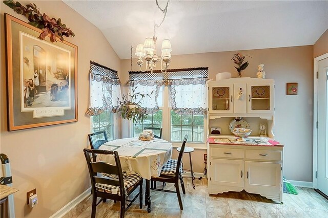 3949 E Summit Ridge Dr, Beavercreek, OH 45430 - dining space with a chandelier, lofted ceiling, and baseboards