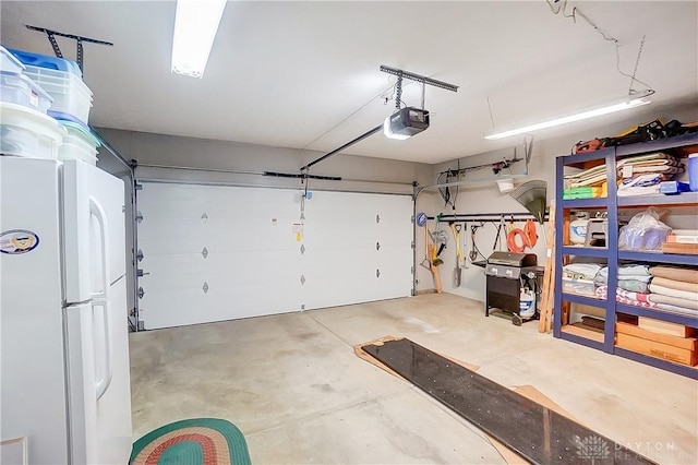 3949 E Summit Ridge Dr, Beavercreek, OH 45430 - garage with freestanding refrigerator and a garage door opener