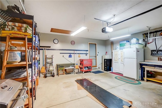 3949 E Summit Ridge Dr, Beavercreek, OH 45430 - garage with freestanding refrigerator and a garage door opener