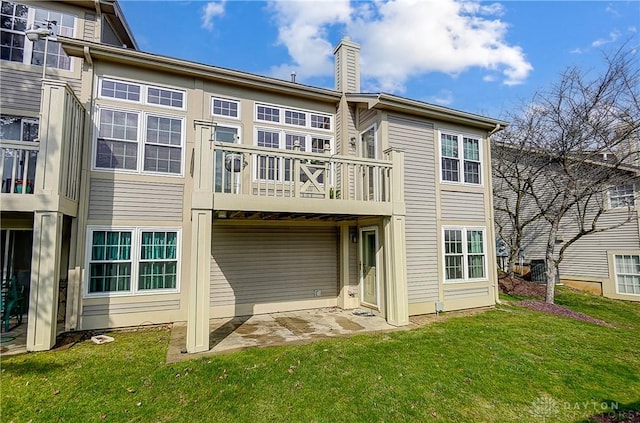 3949 E Summit Ridge Dr, Beavercreek, OH 45430 - rear view of house featuring a chimney, a yard, and a balcony
