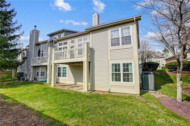 3949 E Summit Ridge Dr, Beavercreek, OH 45430 - back of house with a chimney, central AC unit, and a yard