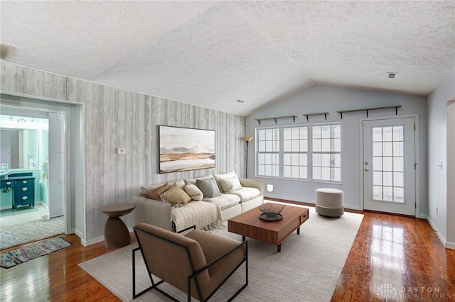 302 Trails Way Unit 27, Miamisburg, OH 45342 - living area featuring wood finished floors, lofted ceiling, baseboards, and a textured ceiling