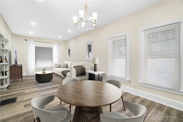 1615 Carrollton Ave, Dayton, OH 45409 - dining room featuring visible vents, baseboards, wood finished floors, recessed lighting, and an inviting chandelier