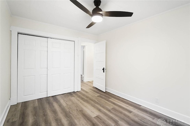 1615 Carrollton Ave, Dayton, OH 45409 - unfurnished bedroom with a closet, baseboards, ornamental molding, wood finished floors, and ceiling fan