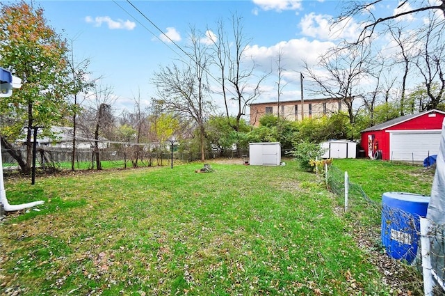 1615 Carrollton Ave, Dayton, OH 45409 - view of yard featuring a garage, fence, a storage unit, and an outdoor structure