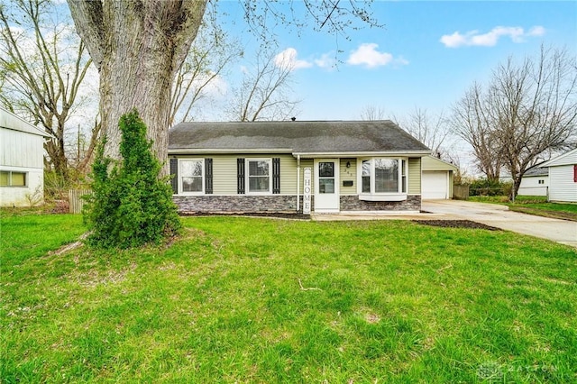 single story home featuring stone siding, a front lawn, and concrete driveway