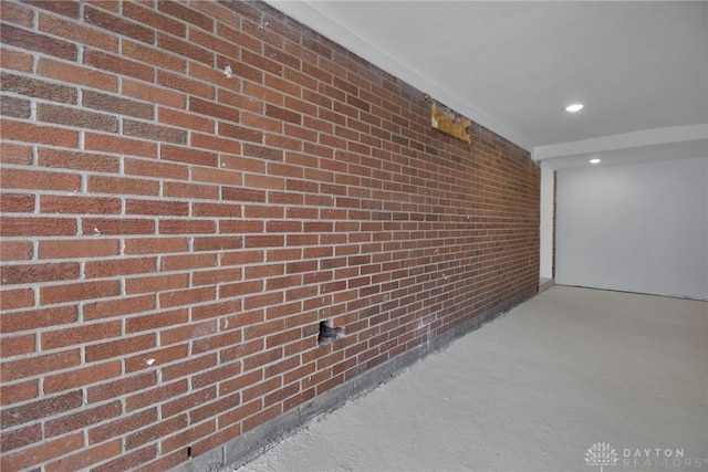 interior space with recessed lighting and brick wall