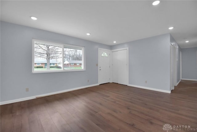 unfurnished living room with recessed lighting, baseboards, and wood finished floors