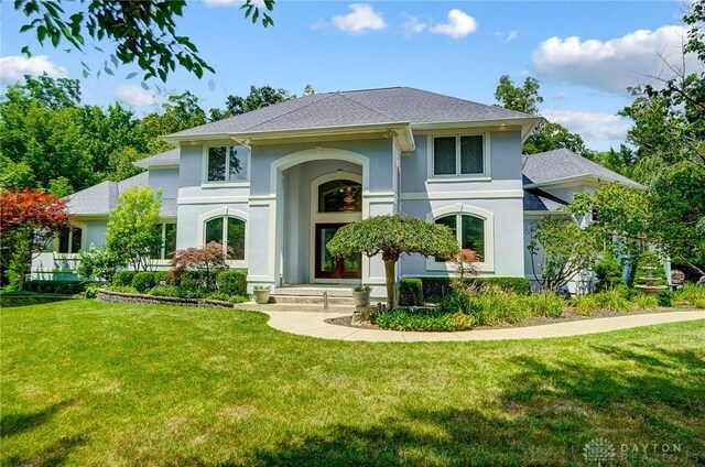 3558 Golden Fox Trl, Lebanon, OH 45036 - front facade featuring a front lawn, a shingled roof, and stucco siding