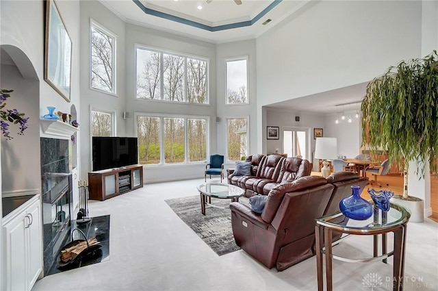 3558 Golden Fox Trl, Lebanon, OH 45036 - carpeted living room with crown molding, a towering ceiling, visible vents, and a wealth of natural light