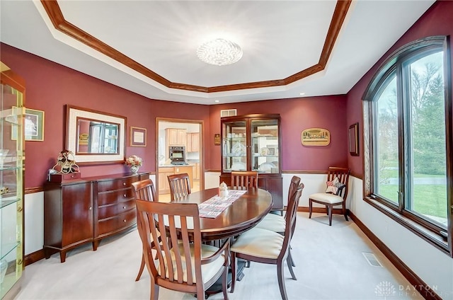 3558 Golden Fox Trl, Lebanon, OH 45036 - dining room with a notable chandelier, visible vents, a tray ceiling, and light carpet