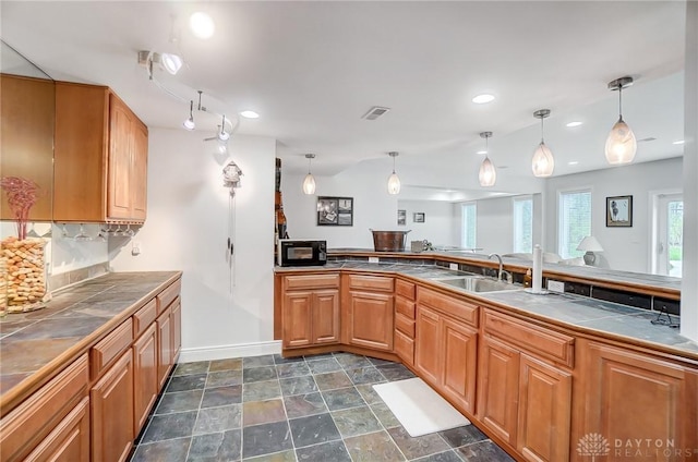 3558 Golden Fox Trl, Lebanon, OH 45036 - kitchen with black microwave, a sink, tile countertops, and visible vents
