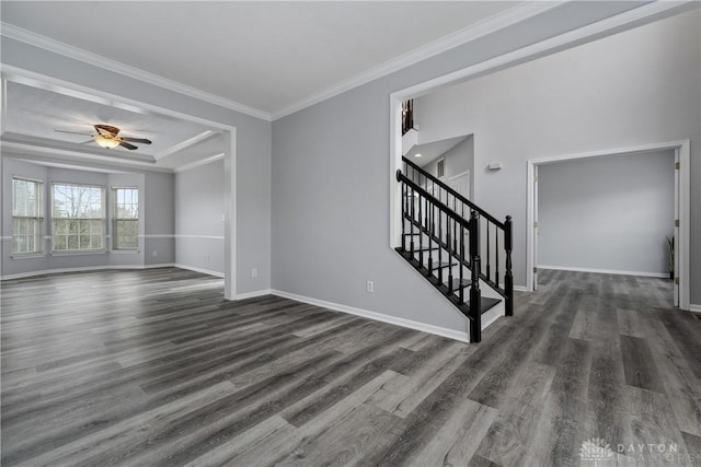 spare room with dark wood-style flooring, crown molding, stairway, and ceiling fan