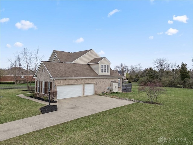 view of side of property featuring roof with shingles, an attached garage, driveway, brick siding, and a lawn