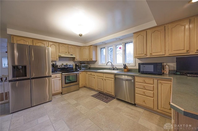 5566 Mad River Rd, Dayton, OH 45459 - kitchen with light brown cabinetry, stainless steel appliances, under cabinet range hood, and a sink