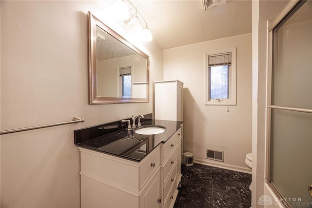 5566 Mad River Rd, Dayton, OH 45459 - full bathroom featuring visible vents, vanity, toilet, baseboards, and a shower with shower door