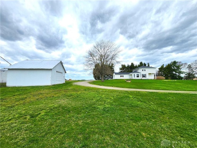 5469 Davis Rd, Jamestown Vlg, OH 45335 - view of yard featuring a detached garage, an outbuilding, and an outdoor structure