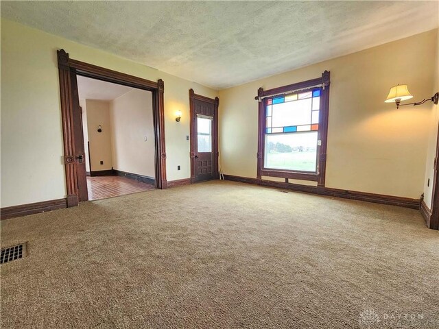 5469 Davis Rd, Jamestown Vlg, OH 45335 - empty room featuring baseboards, carpet floors, a textured ceiling, and visible vents