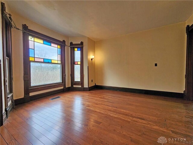 5469 Davis Rd, Jamestown Vlg, OH 45335 - empty room with baseboards, visible vents, and hardwood / wood-style flooring