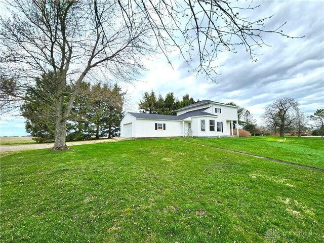 5469 Davis Rd, Jamestown Vlg, OH 45335 - view of front facade featuring driveway, a front lawn, and an attached garage