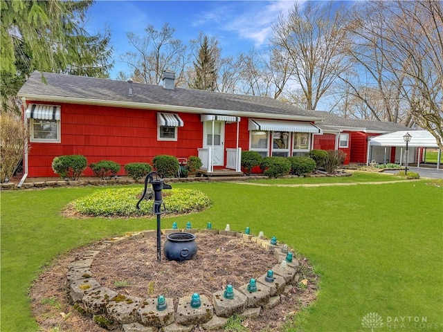 single story home featuring a chimney and a front lawn
