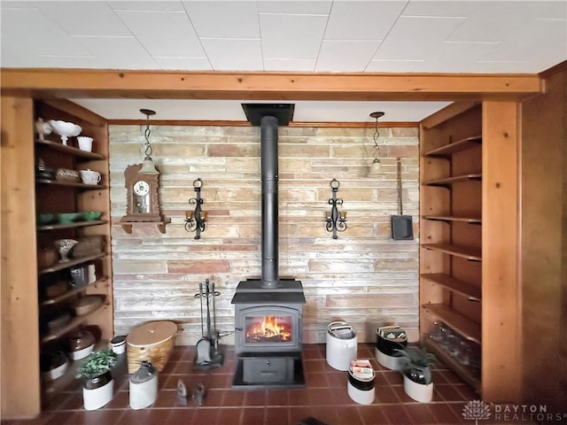 room details featuring wood walls and a wood stove