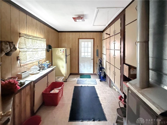 interior space featuring heating unit, ornamental molding, and wood walls