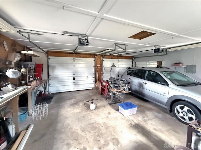 garage with electric panel and a garage door opener