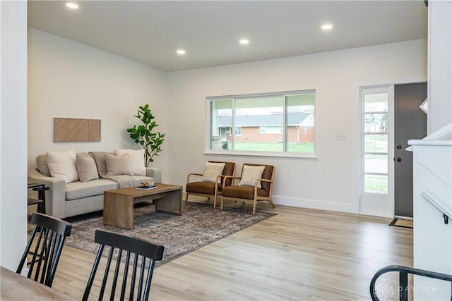 living room featuring wood finished floors, recessed lighting, and plenty of natural light