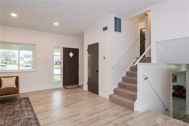 entrance foyer with recessed lighting, light wood-style floors, stairway, and visible vents