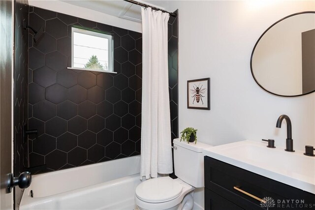bathroom with shower / bathtub combination with curtain, toilet, and vanity