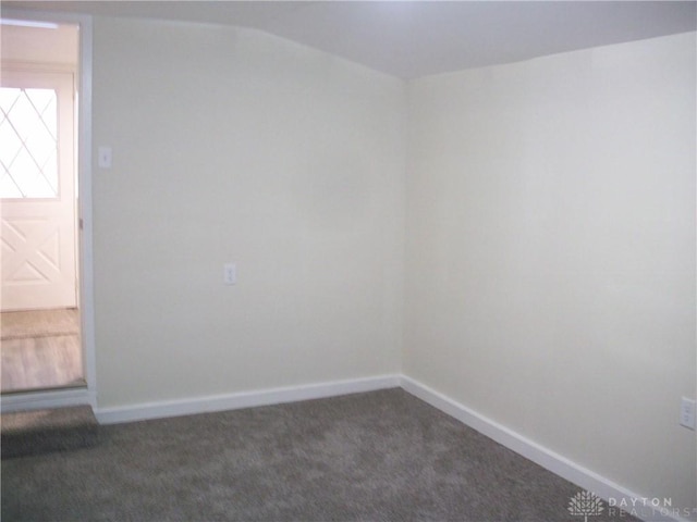 unfurnished room featuring baseboards and carpet flooring