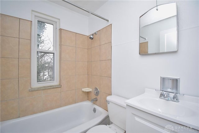 bathroom with toilet, vanity, and bathing tub / shower combination