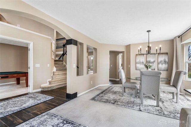 dining space with pool table, wood finished floors, stairway, baseboards, and a chandelier