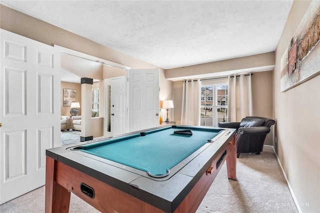 game room with a textured ceiling, baseboards, light colored carpet, and billiards