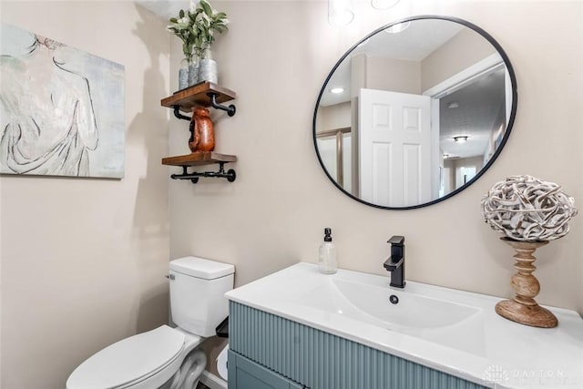 half bathroom featuring toilet and vanity