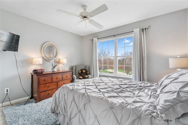 bedroom featuring a ceiling fan and baseboards