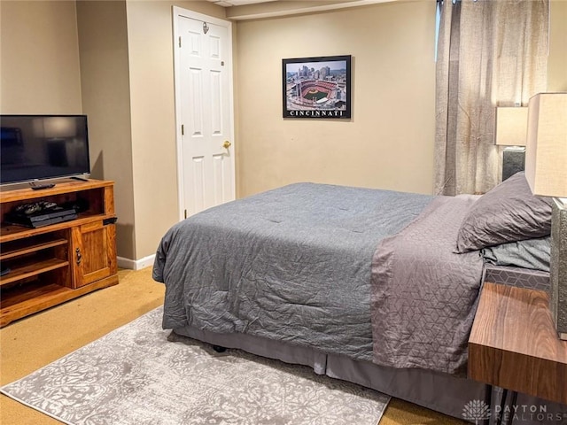 bedroom featuring carpet flooring and baseboards