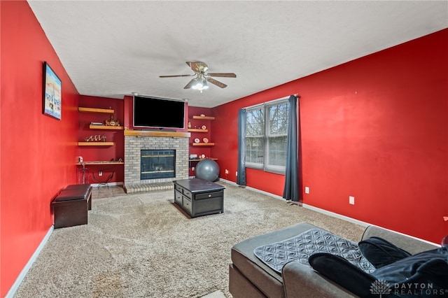 living area with carpet, a brick fireplace, baseboards, and ceiling fan