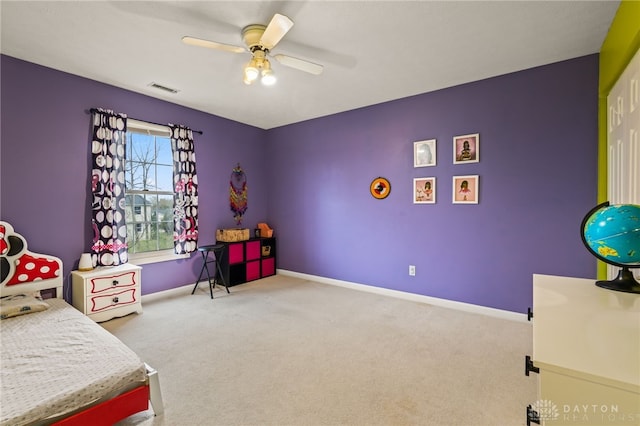 carpeted bedroom with ceiling fan, baseboards, and visible vents