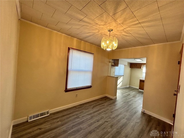 4322 Annapolis Ave, Dayton, OH 45416 - empty room with an inviting chandelier, dark wood-style floors, crown molding, and visible vents