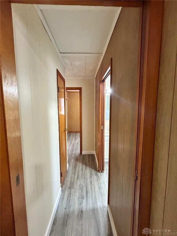 4322 Annapolis Ave, Dayton, OH 45416 - corridor featuring baseboards, wood finished floors, wooden walls, and attic access