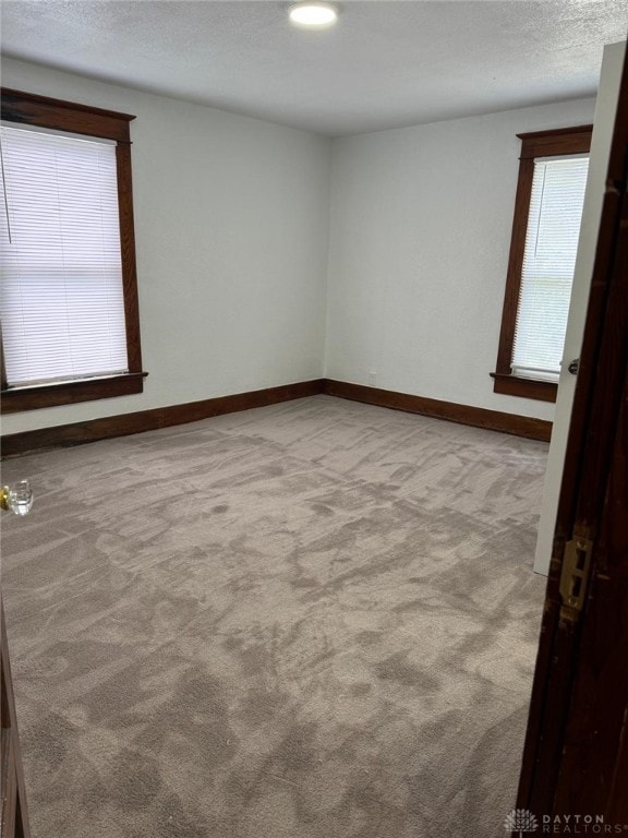 2312 Parkland Ave, Dayton, OH 45405 - carpeted empty room with baseboards and a textured ceiling