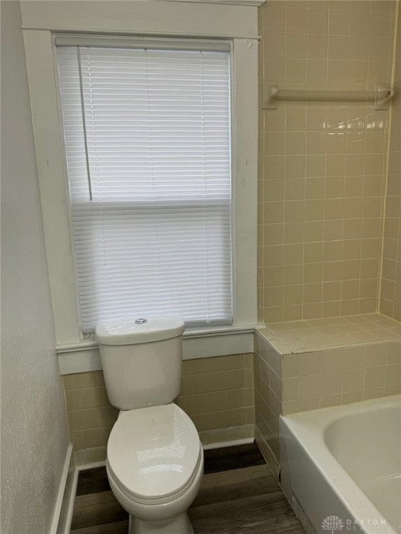 2312 Parkland Ave, Dayton, OH 45405 - full bathroom featuring a bathing tub, toilet, walk in shower, and wood finished floors