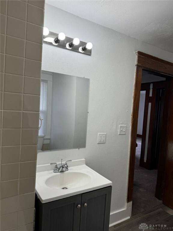 2312 Parkland Ave, Dayton, OH 45405 - bathroom with a textured ceiling, wood finished floors, and vanity